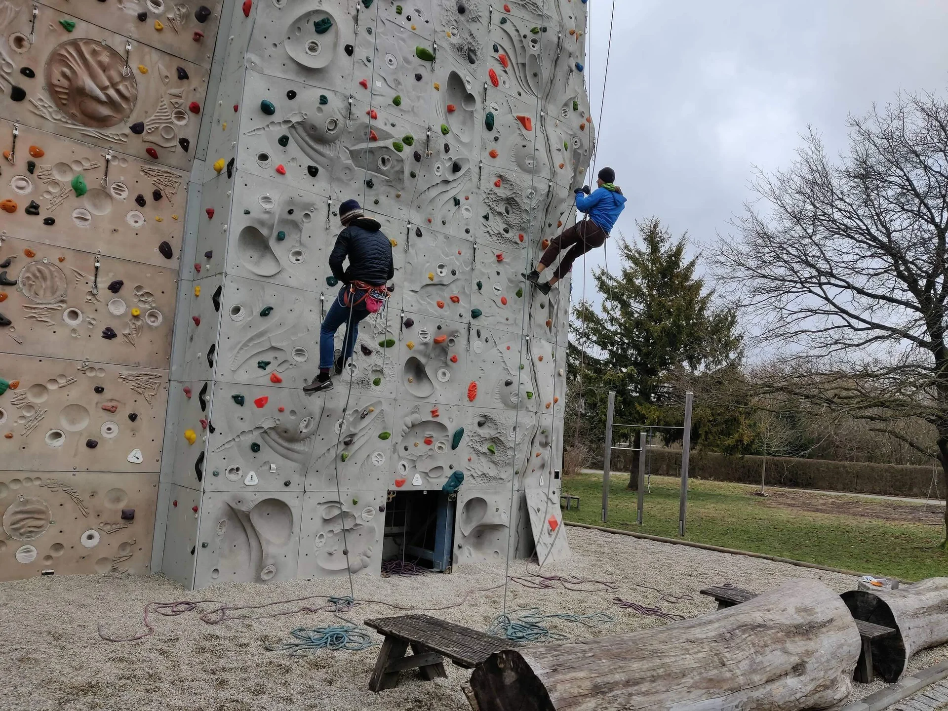 Zwei Personen klettern gesichert an einer bunten Outdoor-Kletterwand. | © DAV Markt Schwaben