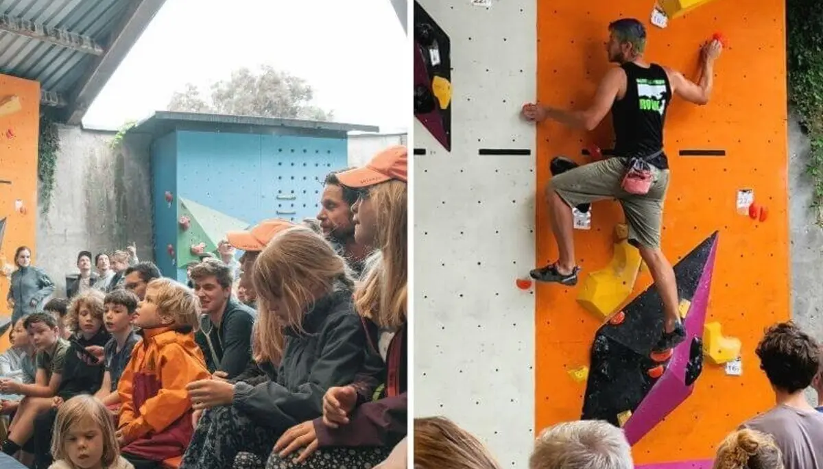 Erwachsene und Kinder verfolgen gespannt einen Kletterwettkampf, während ein Athlet die Boulderwand erklimmt. | © DAV Markt Schwaben | Foto: David Sigl & Anna Thoms