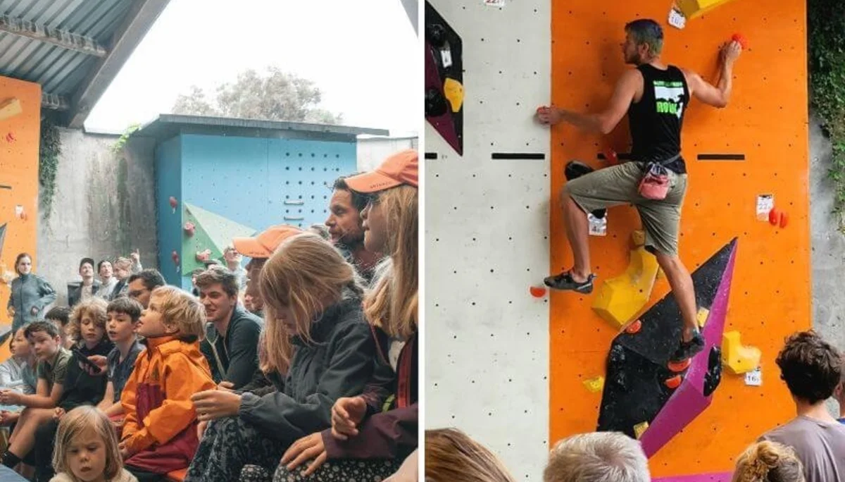 Erwachsene und Kinder verfolgen gespannt einen Kletterwettkampf, während ein Athlet die Boulderwand erklimmt. | © DAV Markt Schwaben | Foto: David Sigl & Anna Thoms